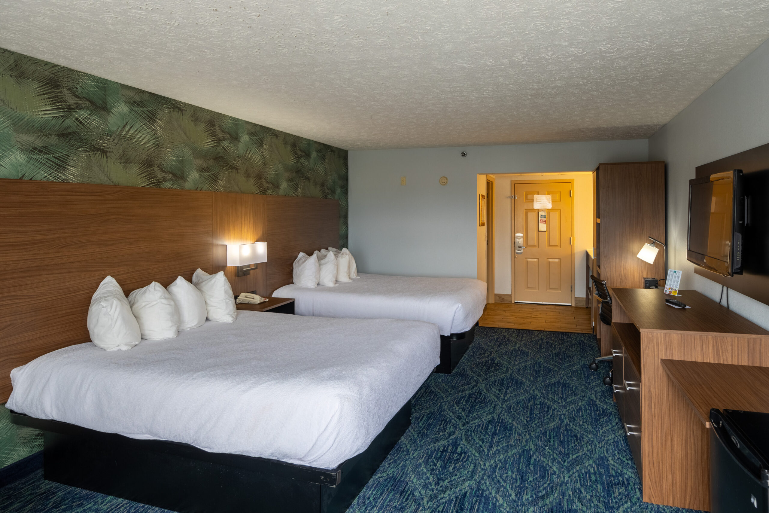 spacious hotel room with two queen beds at Park Grove Inn