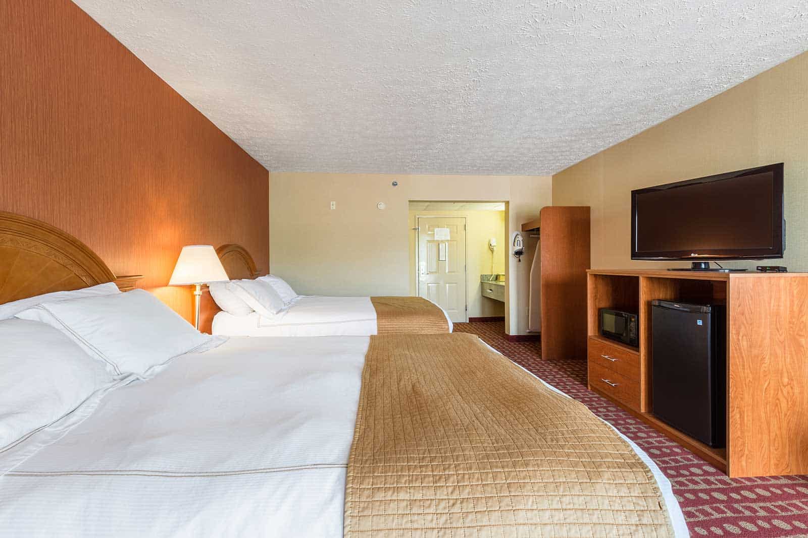 spacious hotel room with two queen beds at Park Grove Inn Pigeon Forge